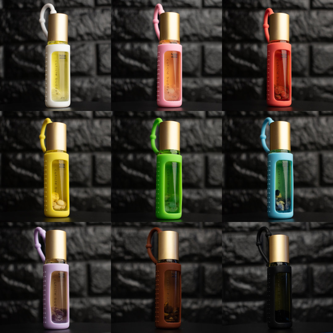 collage of 9 bottles of cuticle oil in different scents and silicone holders all with gold aluminum caps