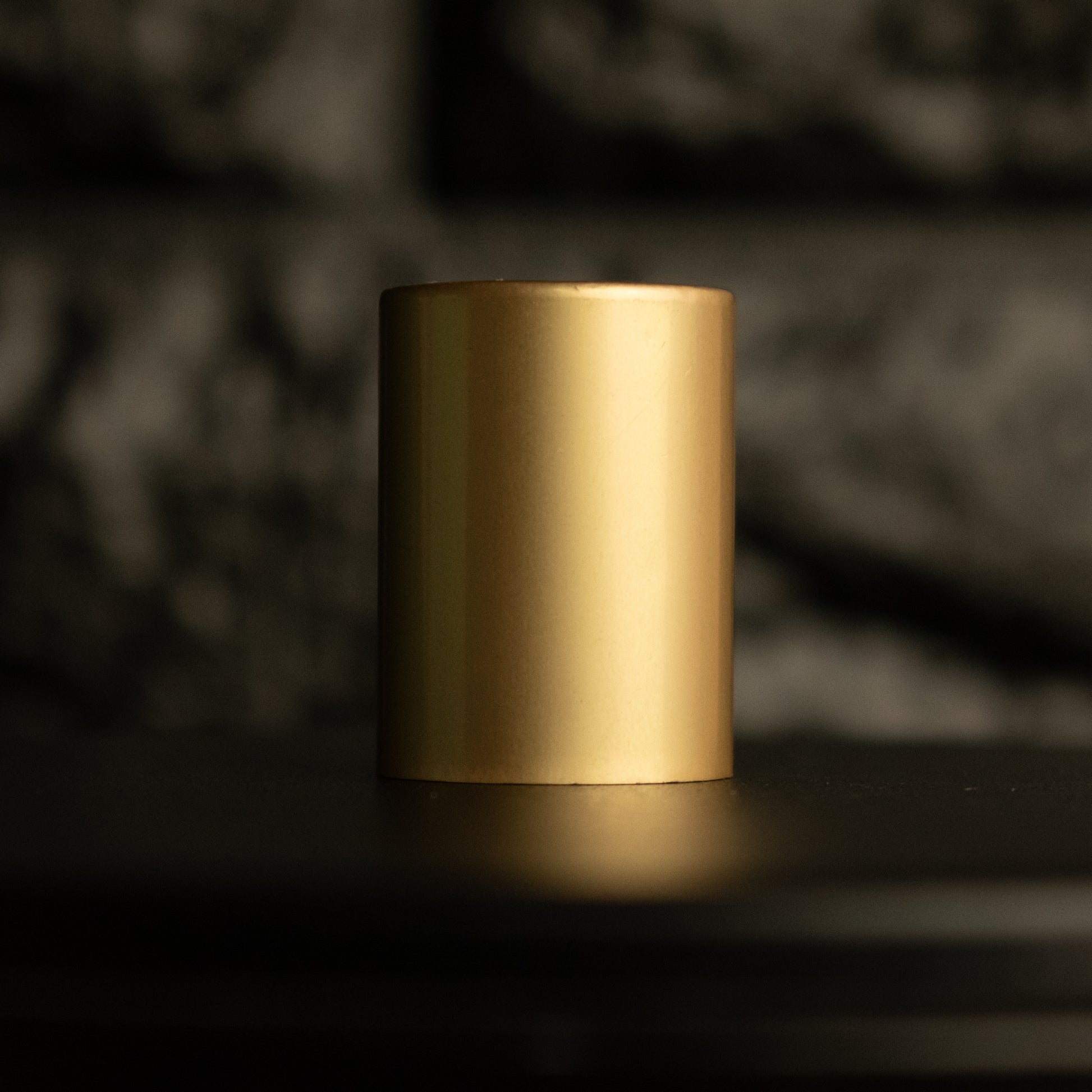 a gold aluminum cap on a black background