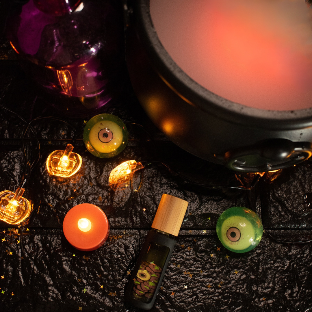 bottle of cuticle oil in a flat lay with halloween decorations