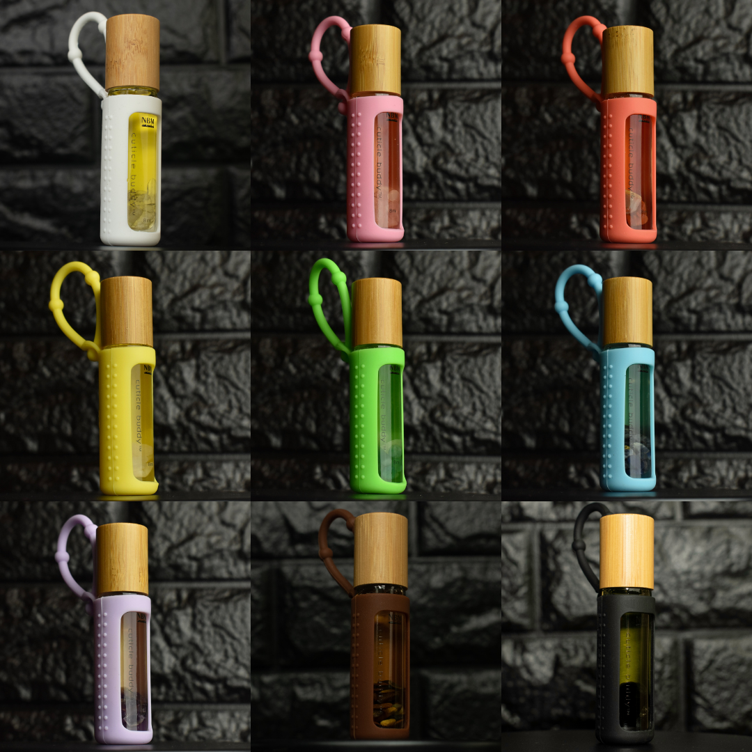 collage of 9 cuticle buddies in different color silicone holders on a black brick background