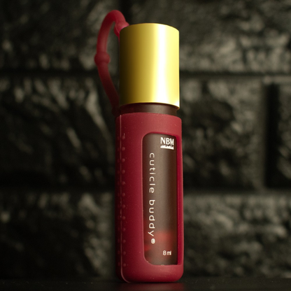red frosted bottle labeled cuticle buddy 8ml  in a red silicone holder with a gold aluminum cap