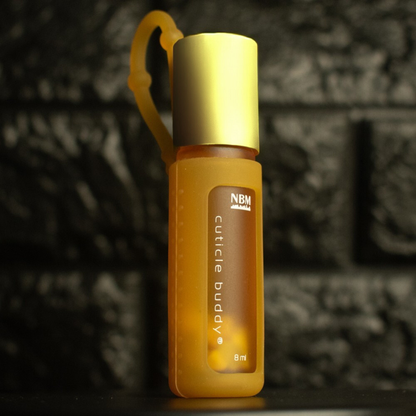 yellow frosted bottle labeled cuticle buddy 8ml  in a yellow silicone holder with a gold aluminum cap