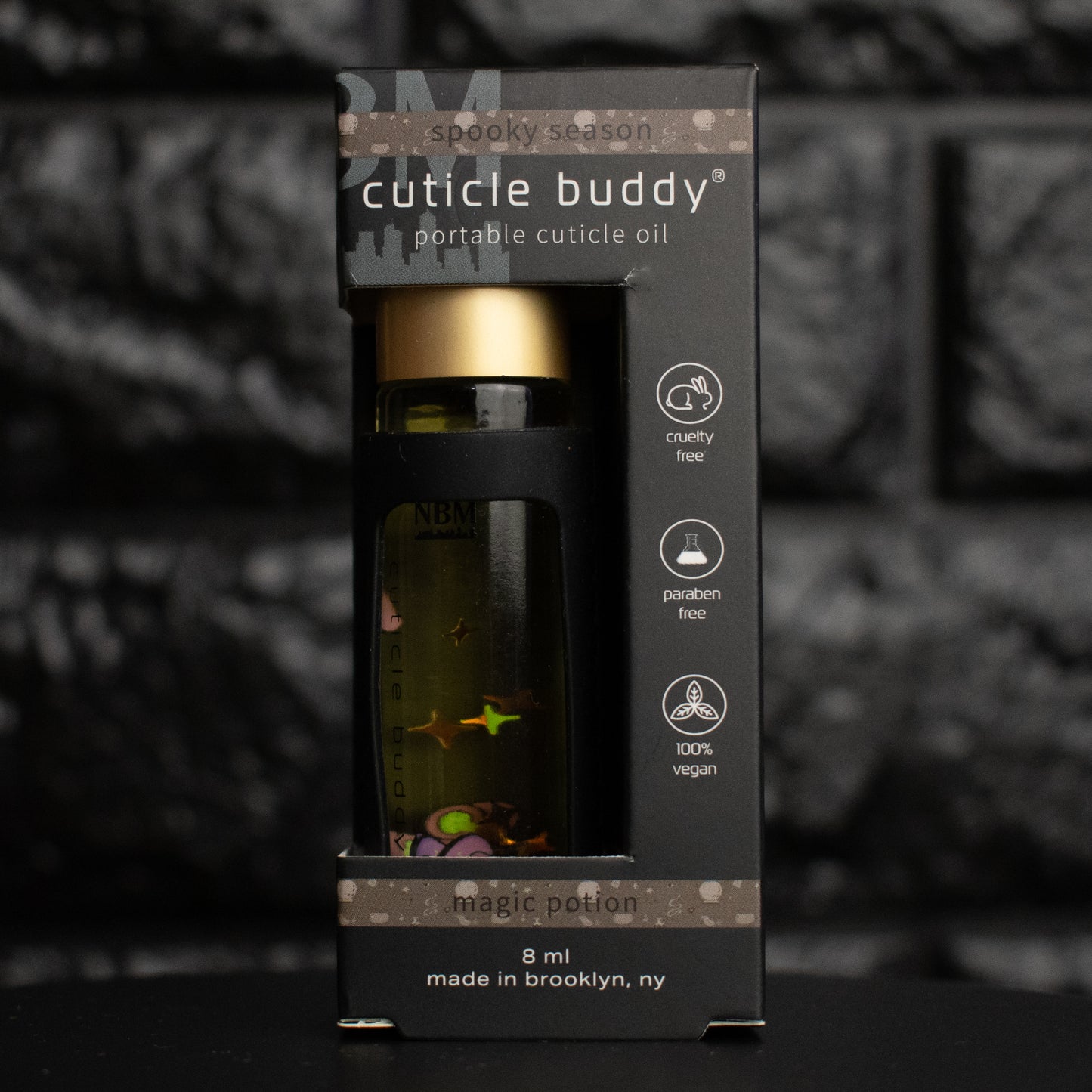 Cuticle buddy portable cuticle oil packaging with a dark background