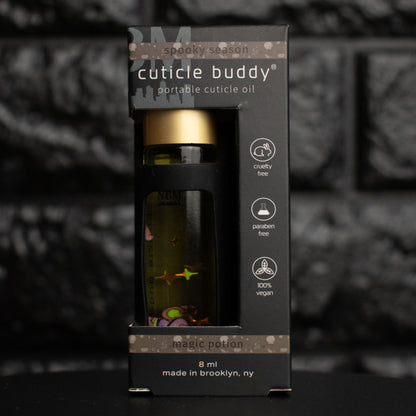 Cuticle buddy portable cuticle oil packaging with a dark background