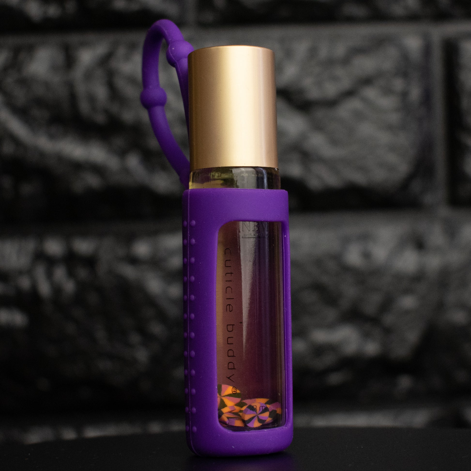Purple and gold bottle with a textured background